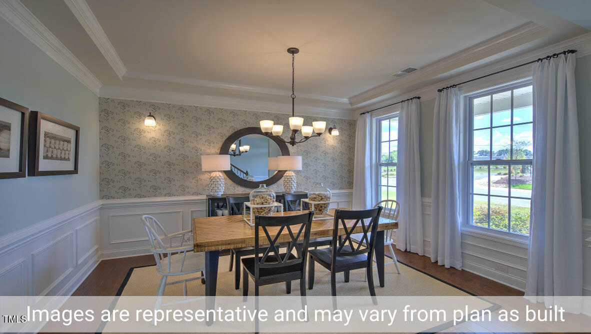 1857 Old Fields Boulevard Haw River, NC 27258 - Photo 11 of 53 a view of a dining room and chandelier fan