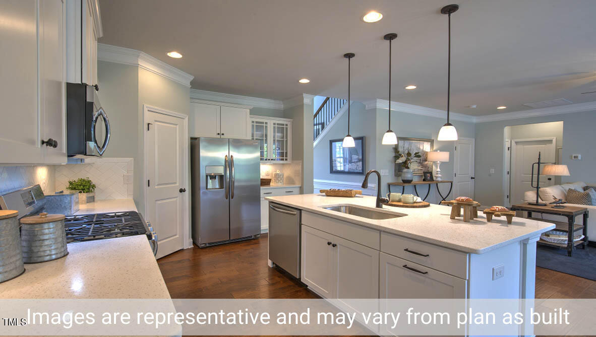 1857 Old Fields Boulevard Haw River, NC 27258 - Photo 23 of 53 a kitchen with a sink a counter top space stainless steel appliances and cabinets