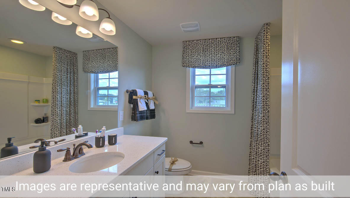 1857 Old Fields Boulevard Haw River, NC 27258 - Photo 25 of 53 a bathroom with a sink a mirror and a shower