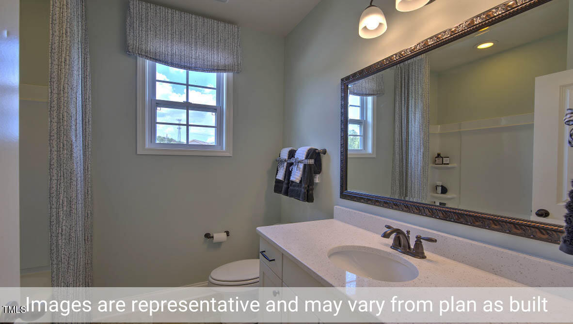 1857 Old Fields Boulevard Haw River, NC 27258 - Photo 27 of 53 a bathroom with a sink a mirror and a window