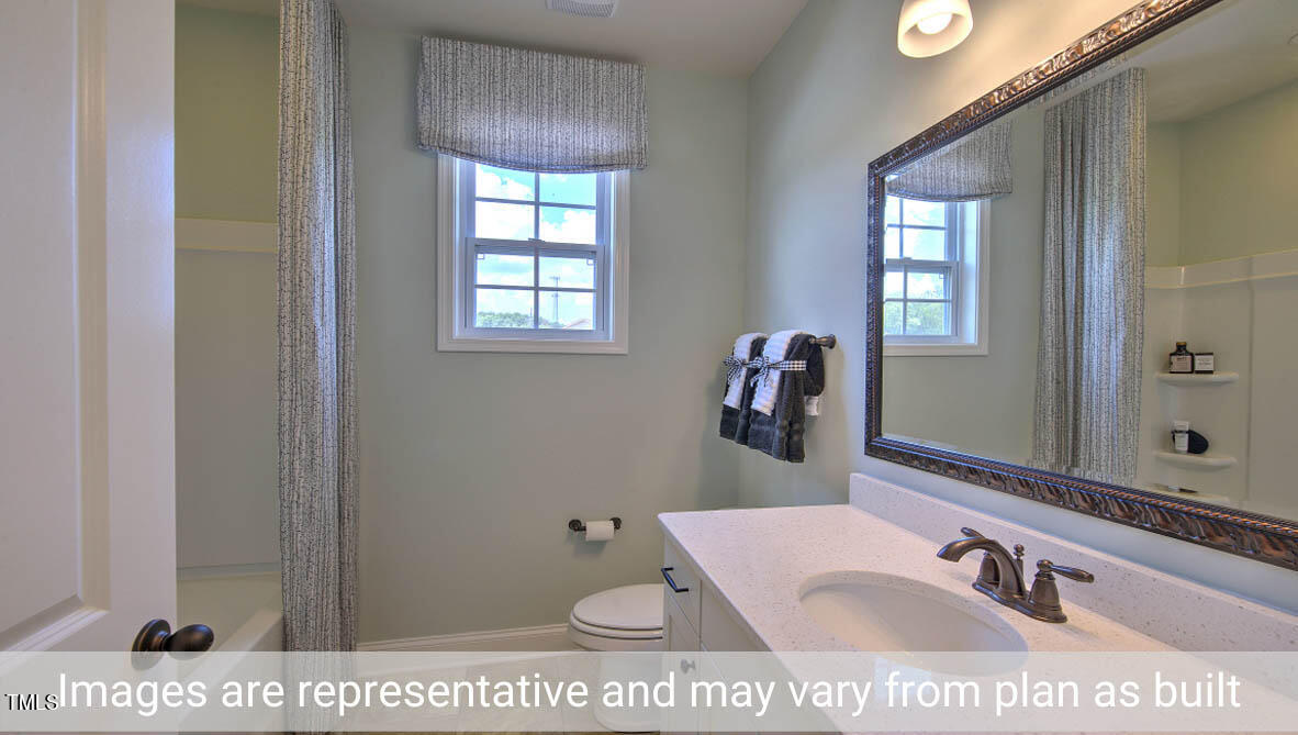 1857 Old Fields Boulevard Haw River, NC 27258 - Photo 28 of 53 a bathroom with a sink a vanity and mirror
