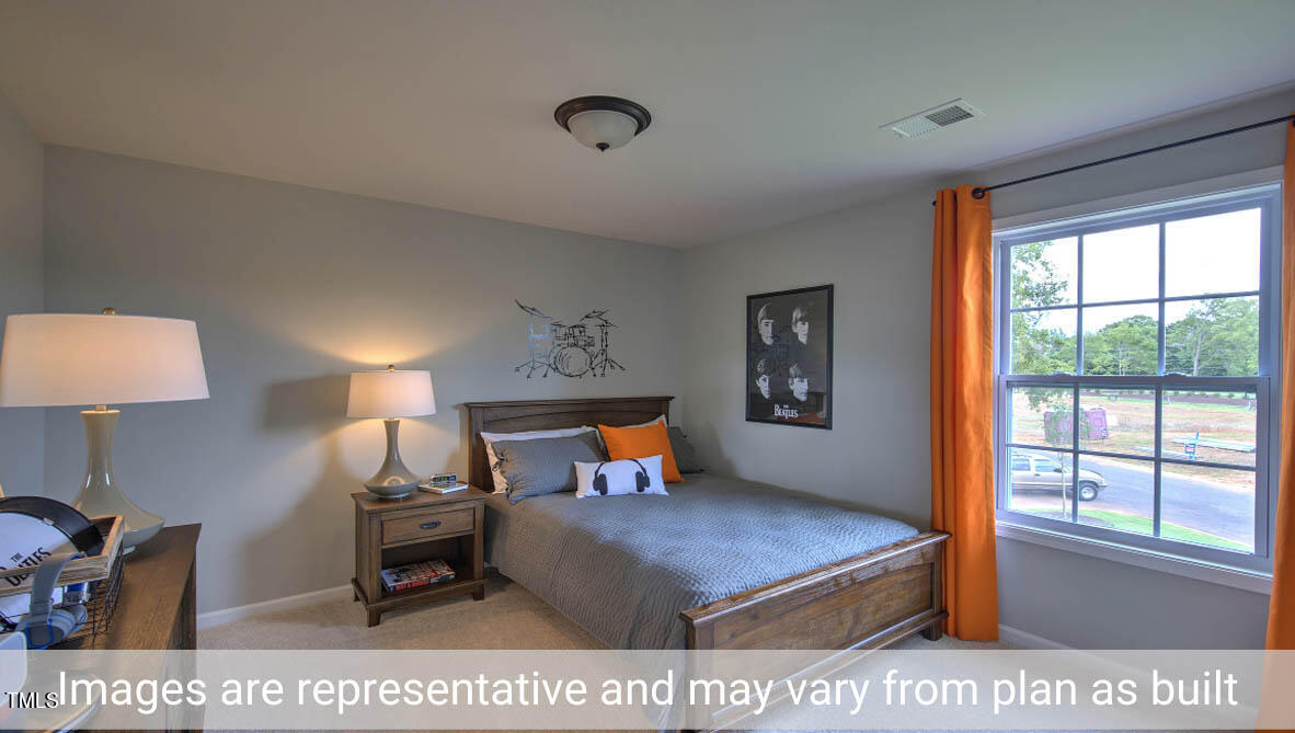 1857 Old Fields Boulevard Haw River, NC 27258 - Photo 32 of 53 a bedroom with a bed a lamp and a large window