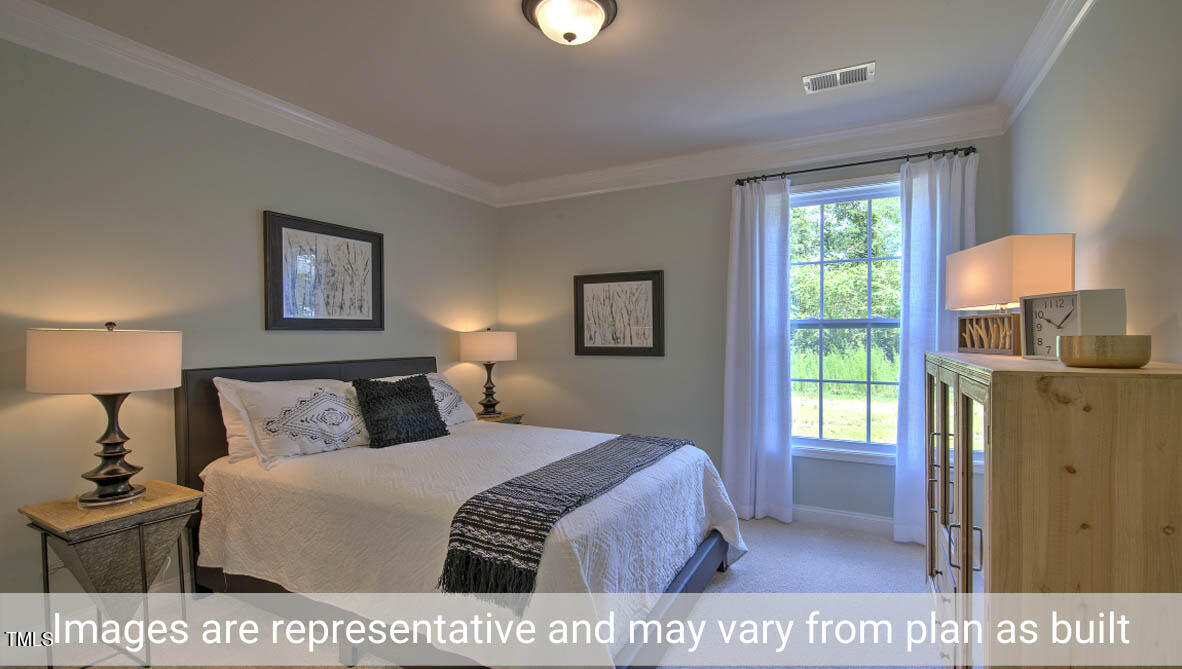 1857 Old Fields Boulevard Haw River, NC 27258 - Photo 36 of 53 a bedroom with a bed and a window