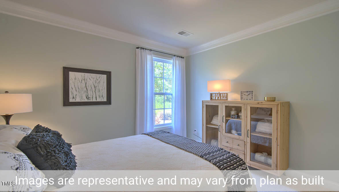 1857 Old Fields Boulevard Haw River, NC 27258 - Photo 37 of 53 a bedroom with a bed and a large window