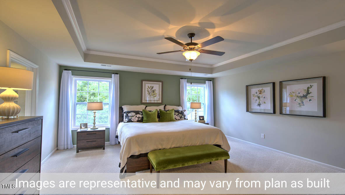 1857 Old Fields Boulevard Haw River, NC 27258 - Photo 50 of 53 a bedroom with a bed a chandelier and a window