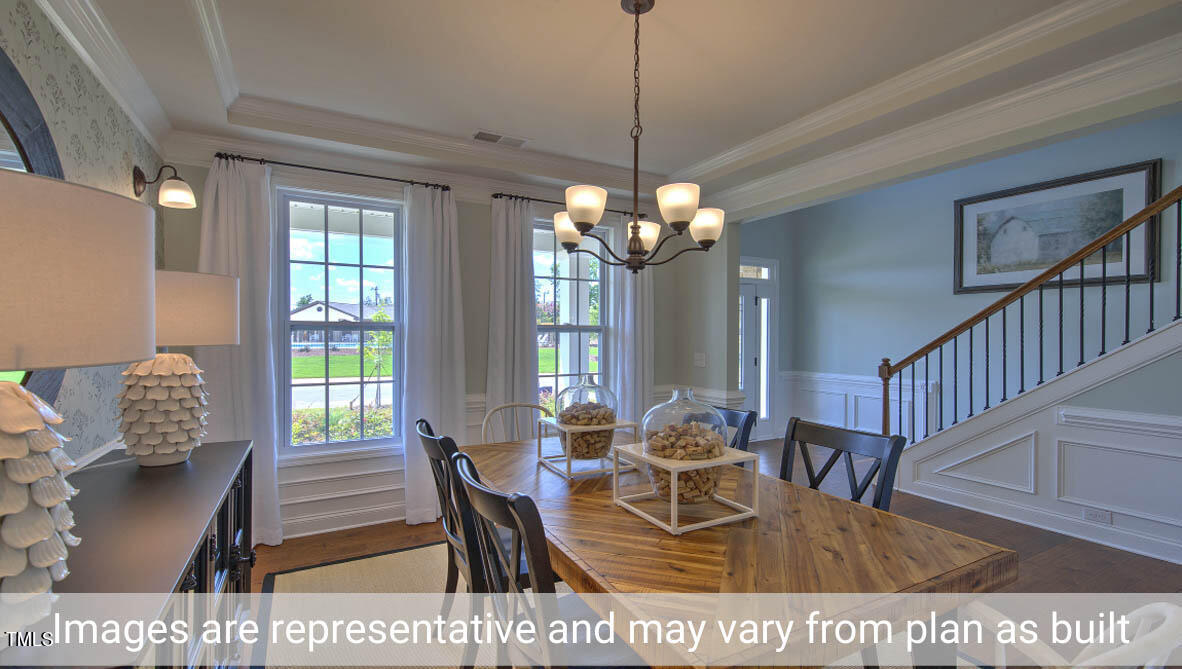 1857 Old Fields Boulevard Haw River, NC 27258 - Photo 9 of 53 a view of a dining room with furniture window and wooden floor