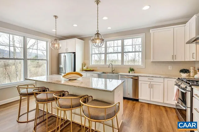 a large kitchen with a table and chairs