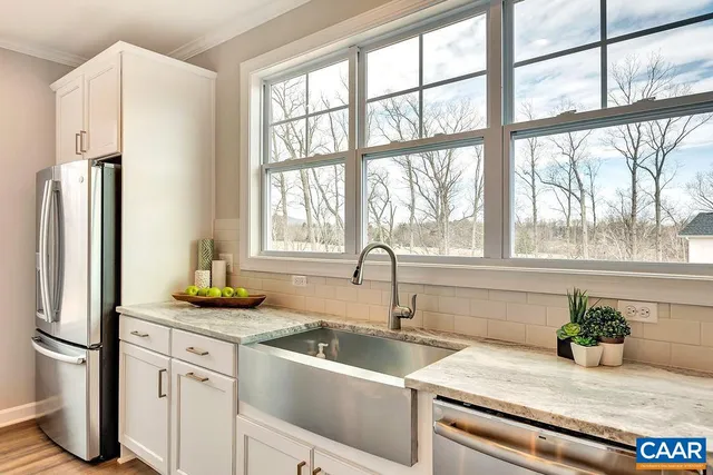 a kitchen with sink refrigerator and window
