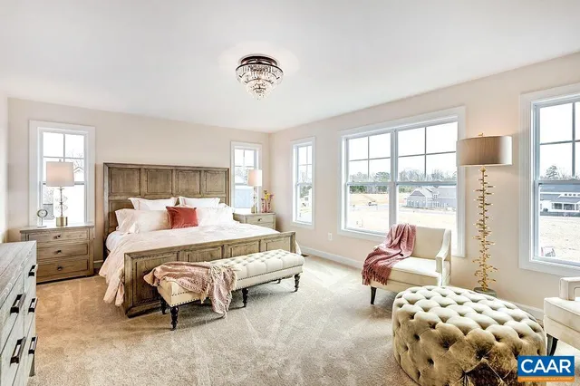 a bedroom with bed and large windows