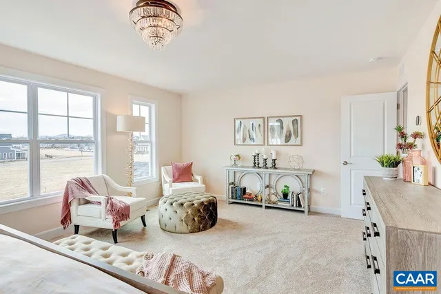 a spacious bedroom with a bed and a couch