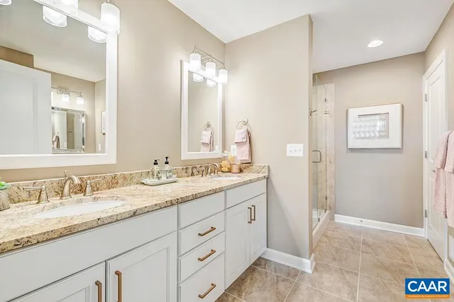 a bathroom with a granite countertop sink mirror and double