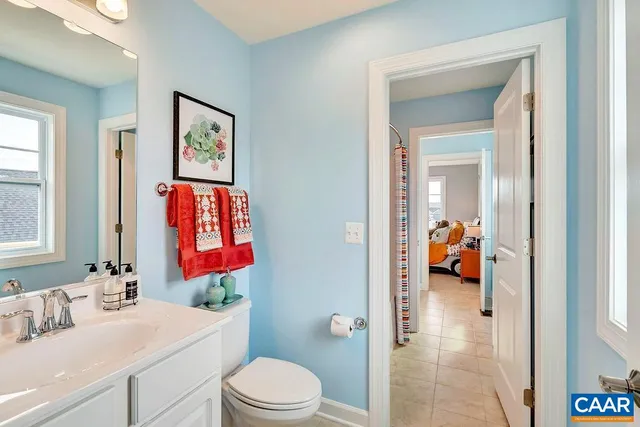 a bathroom with a sink vanity mirror and a toilet