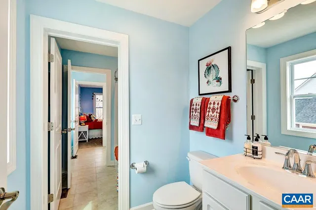 a bathroom with a sink vanity mirror and toilet