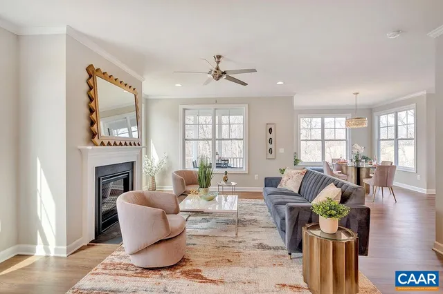 a living room with fireplace furniture and a wooden floor