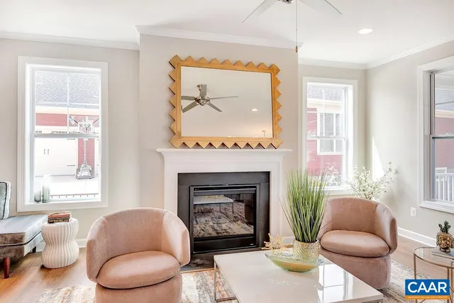 a living room with furniture a window and a fireplace