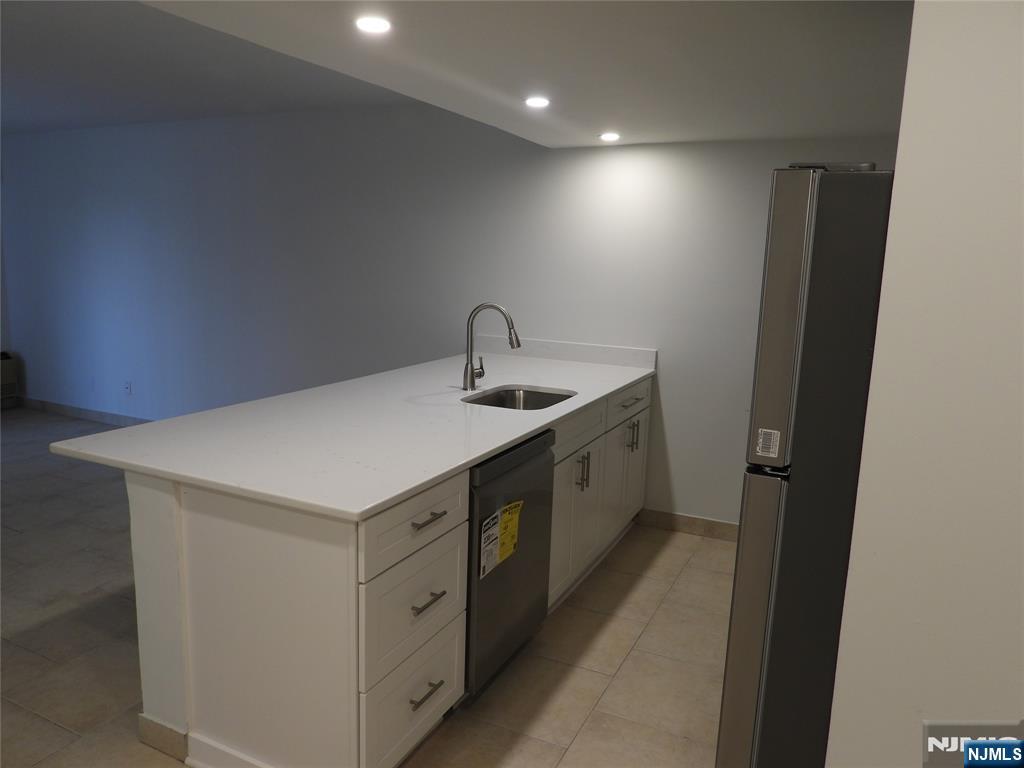 55 Clinton Place, Unit 301 Hackensack, NJ 07601 - Photo 7 of 17 a kitchen with a sink and a refrigerator