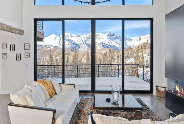 a living room with furniture and a floor to ceiling window