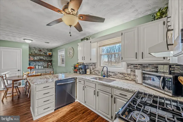 a kitchen with a sink stove and cabinets