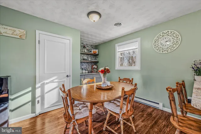a dining room with furniture and window