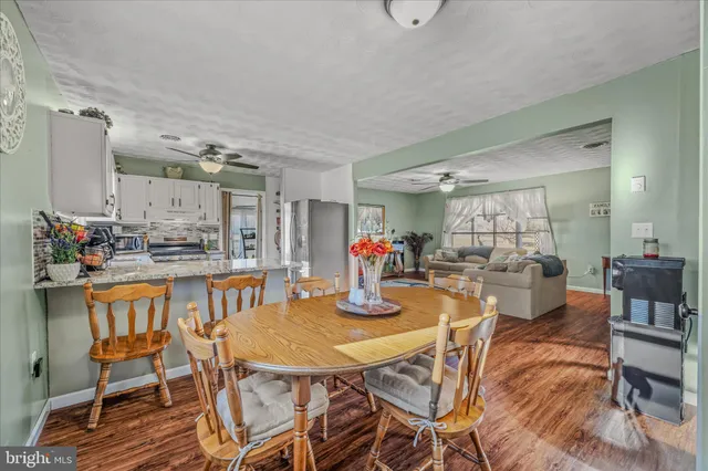 a dining room with a table and chairs
