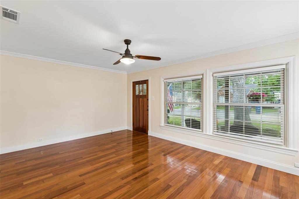 2427 Alco Avenue Dallas, TX 75211 - Photo 11 of 26 a view of an empty room with wooden floor and a window