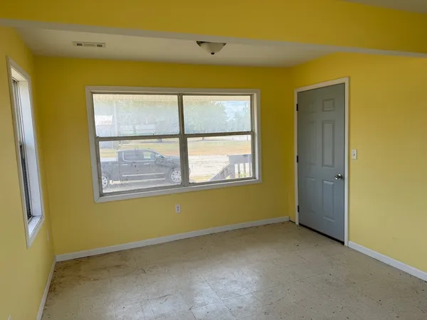 a view of an empty room with a window