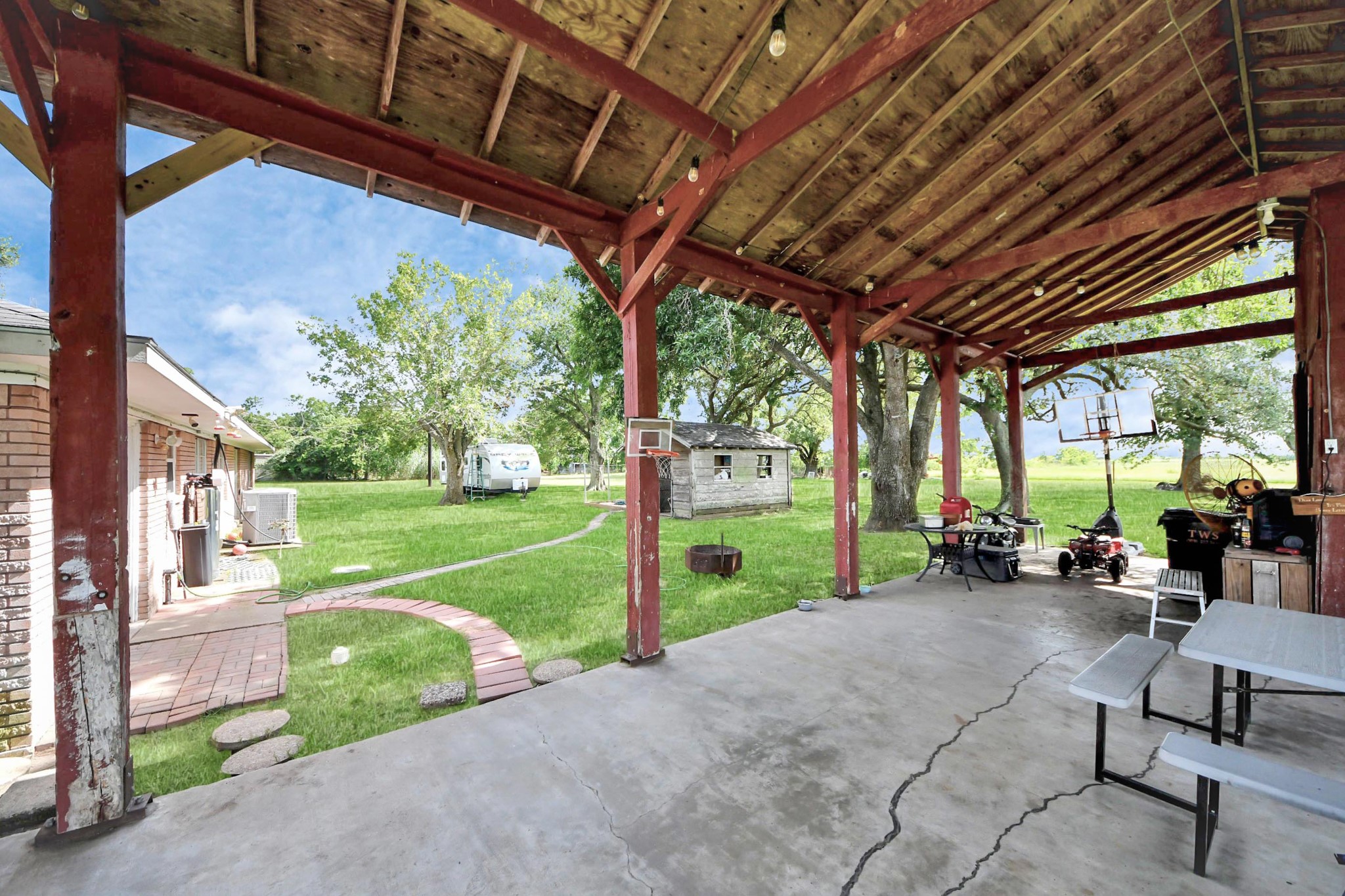2990 FM 1163 Road El Campo, TX 77437 - Photo 18 of 50 a view of a porch with furniture and a yard