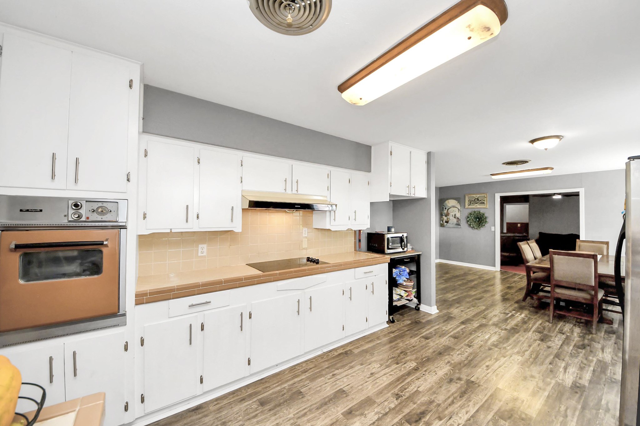 2990 FM 1163 Road El Campo, TX 77437 - Photo 28 of 50 a kitchen with stainless steel appliances a stove a sink cabinets and a wooden floor