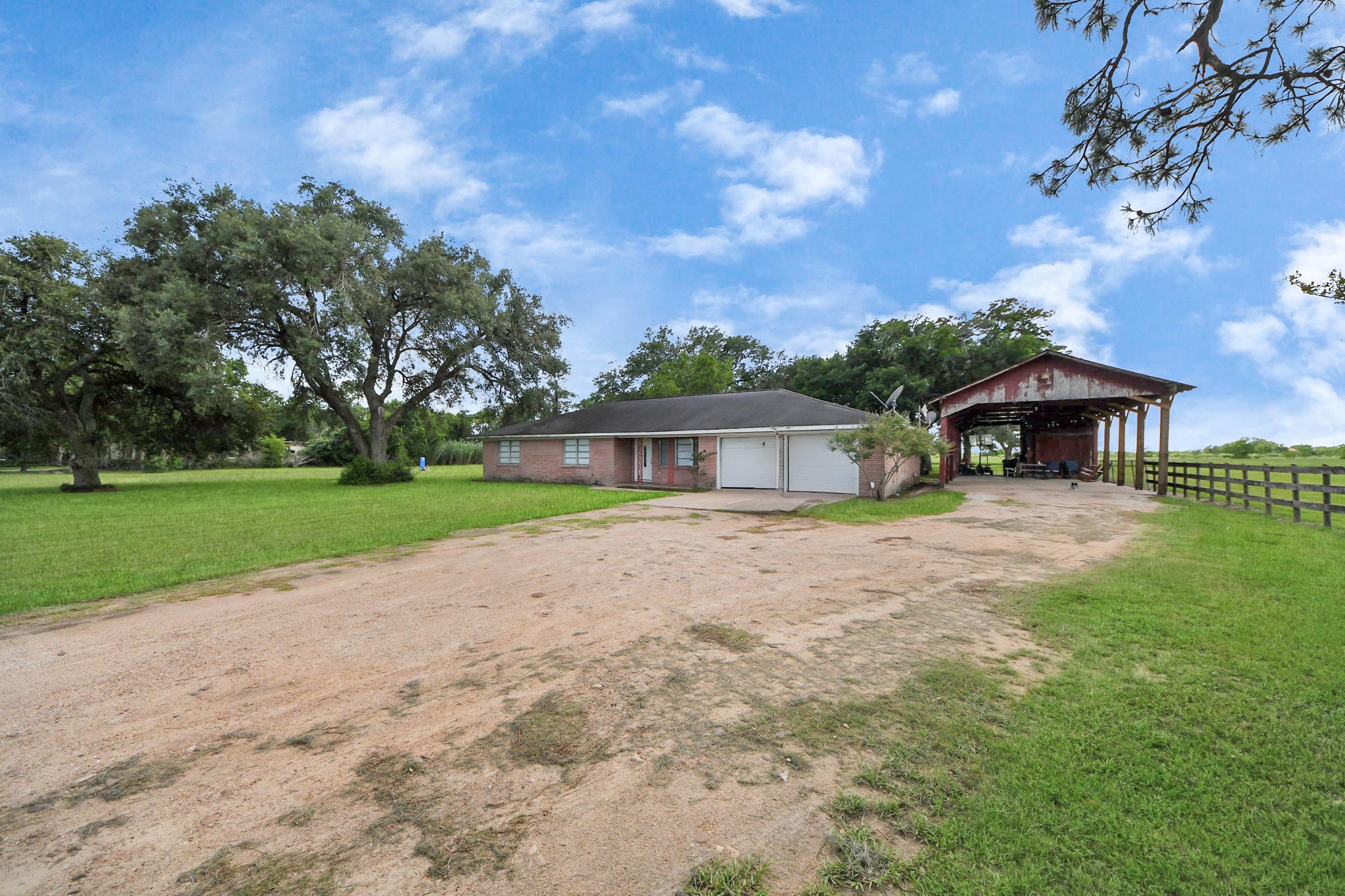 2990 FM 1163 Road El Campo, TX 77437 - Photo 5 of 50 a front view of a house with yard and green space