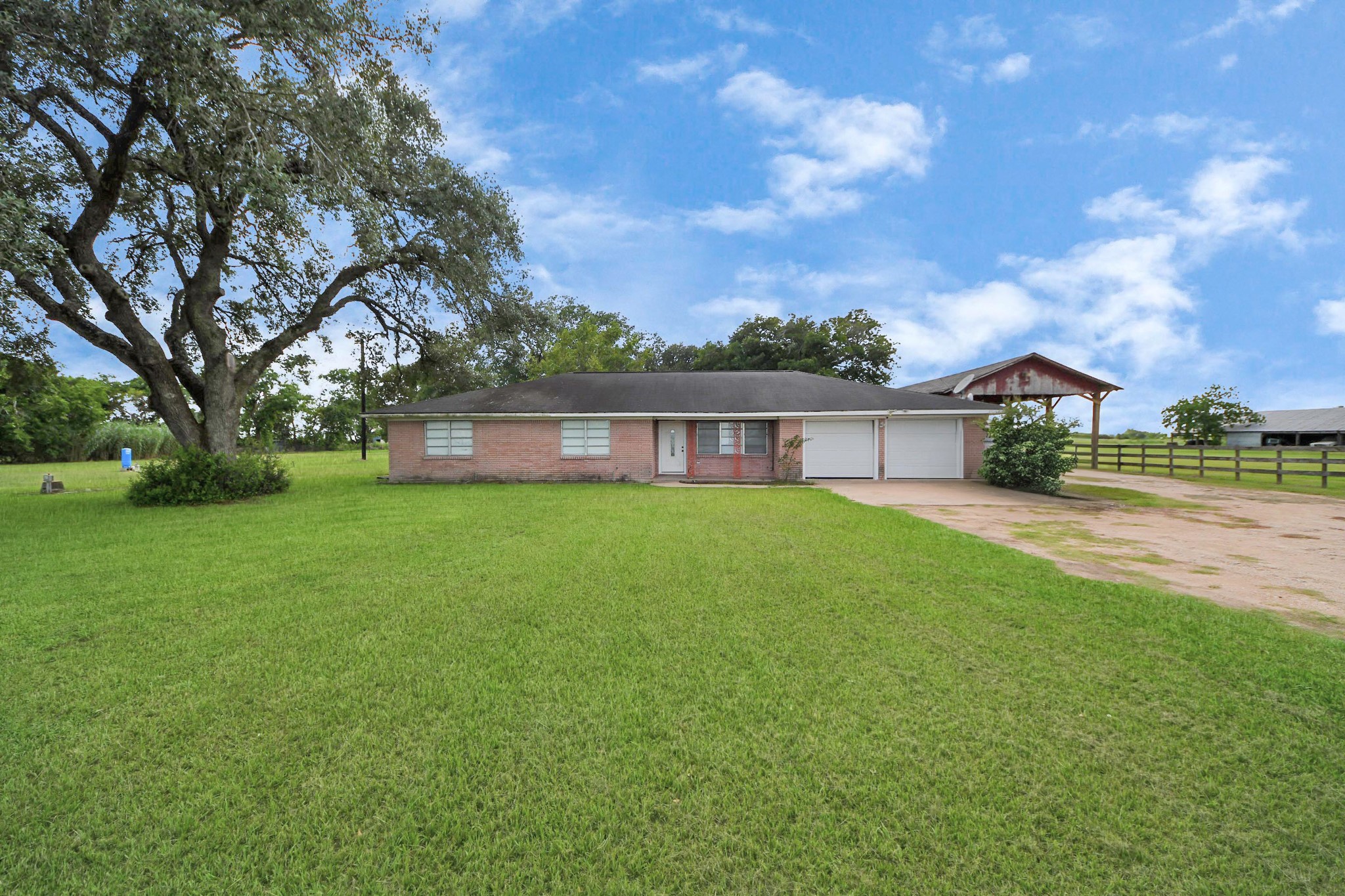 2990 FM 1163 Road El Campo, TX 77437 - Photo 6 of 50 a front view of house with yard and green space