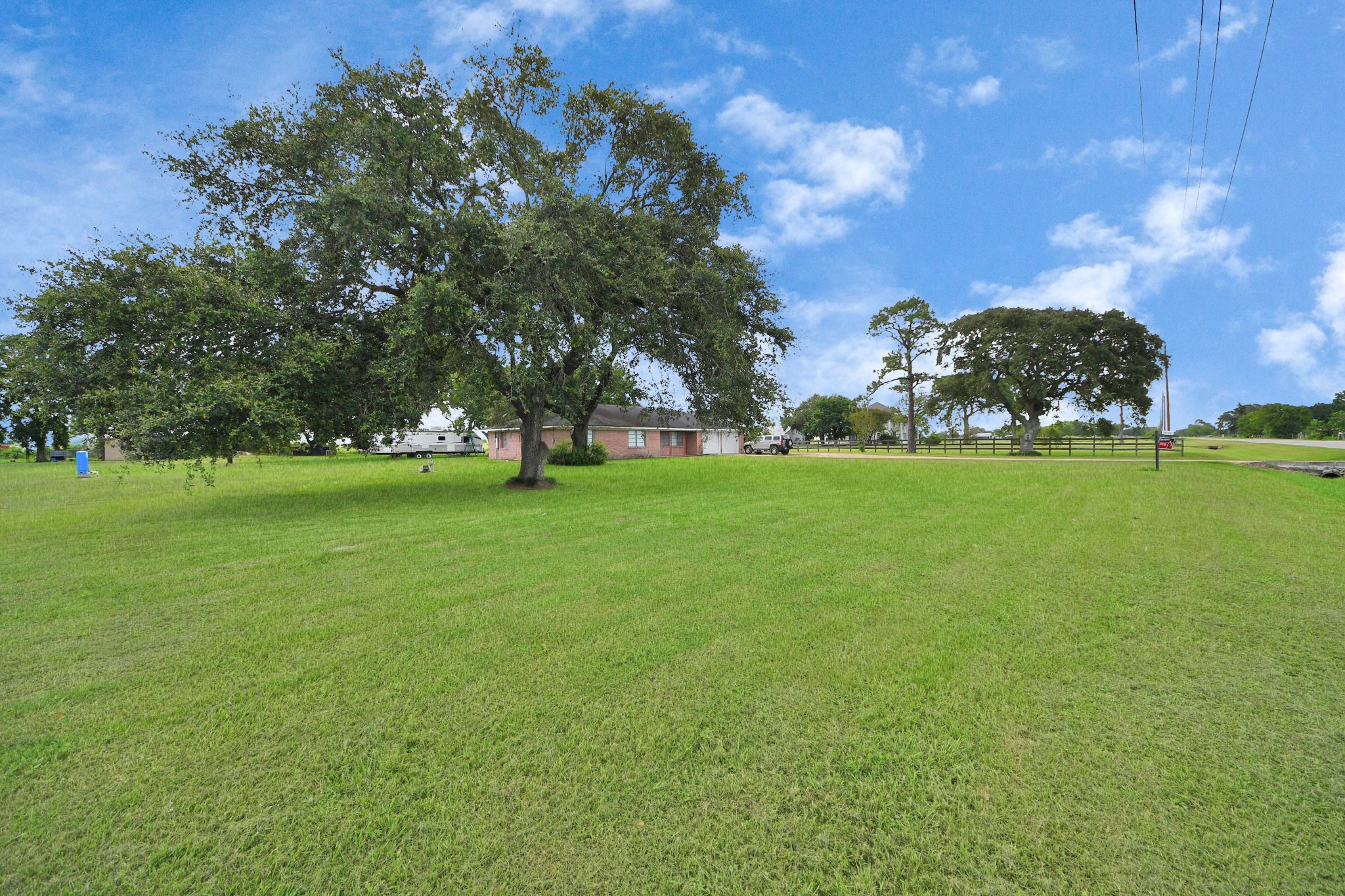 2990 FM 1163 Road El Campo, TX 77437 - Photo 7 of 50 a view of a field of grass and trees