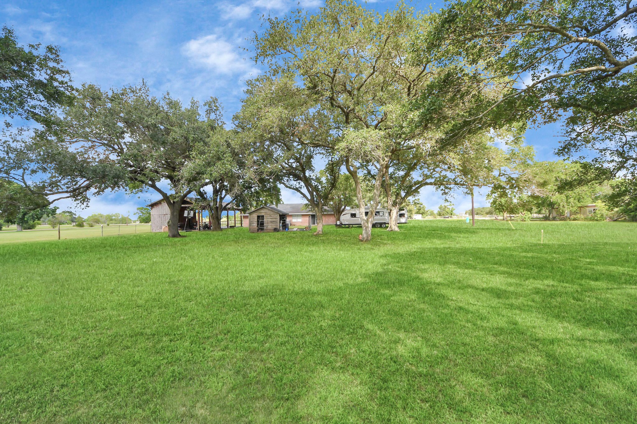 2990 FM 1163 Road El Campo, TX 77437 - Photo 9 of 50 a view of green field with trees in the background
