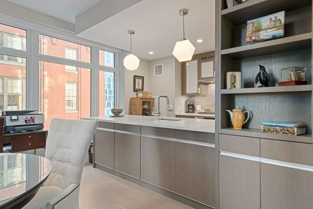 a kitchen with stainless steel appliances granite countertop a sink stove and cabinets