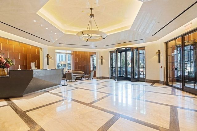 a view of a patio with dining table and chairs with wooden floor and fence