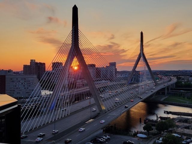 a green field with building in front of it