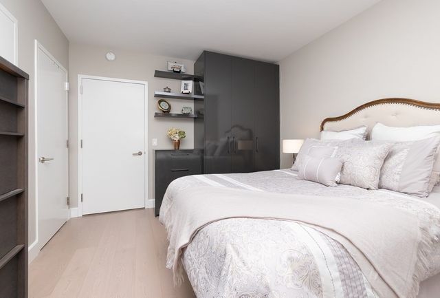 a bedroom with a bed and painting on the wall