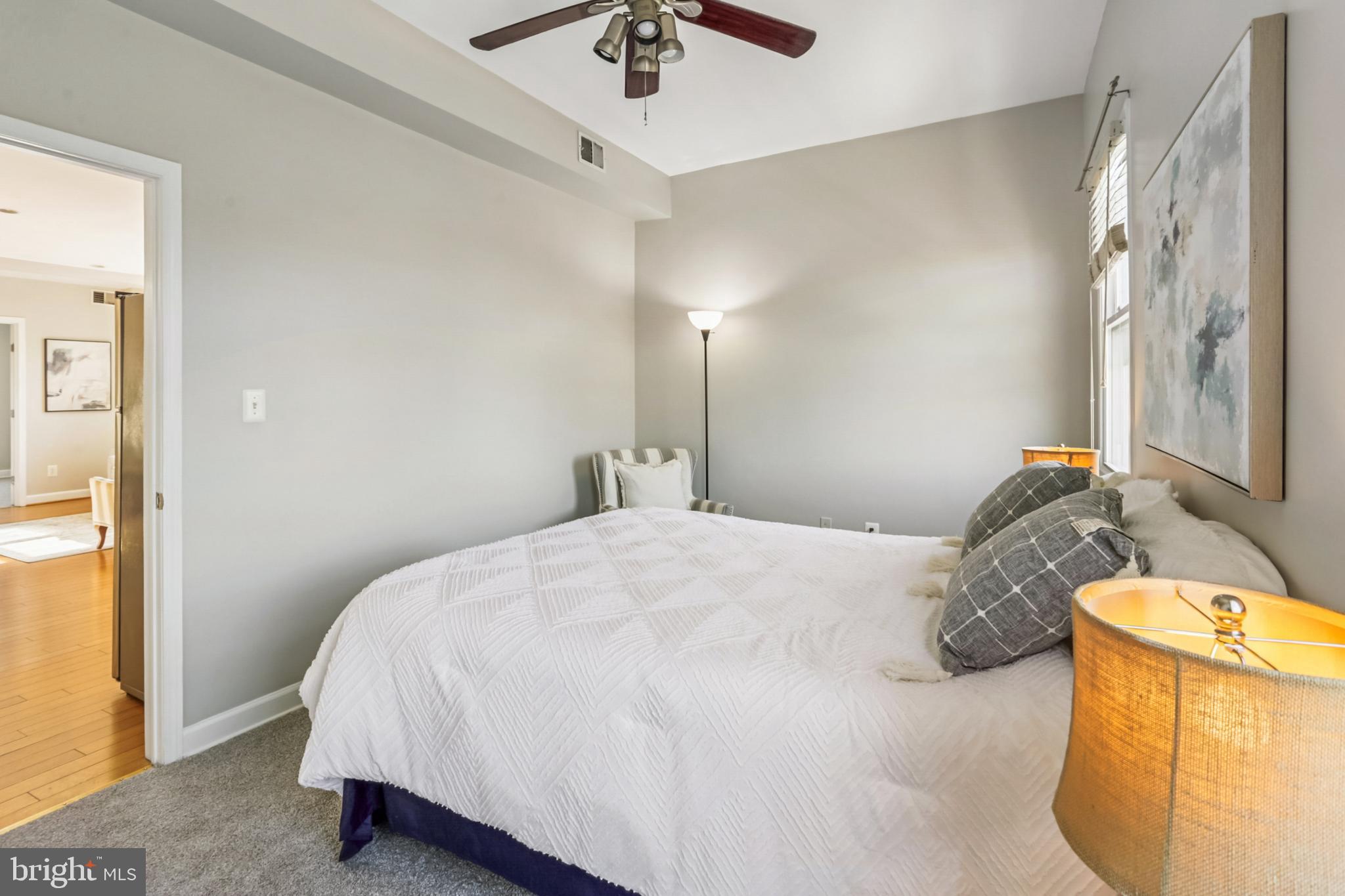 5501 8th Street Northwest, Unit 4 Washington, DC 20011 - Photo 12 of 38 a bedroom with a bed and a chandelier