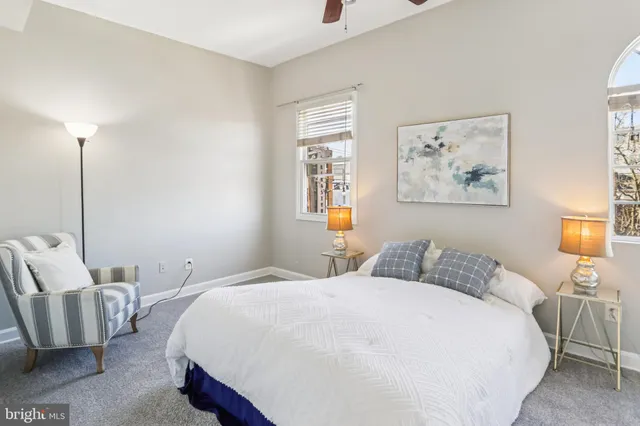 a bedroom with a bed and a painting on the wall