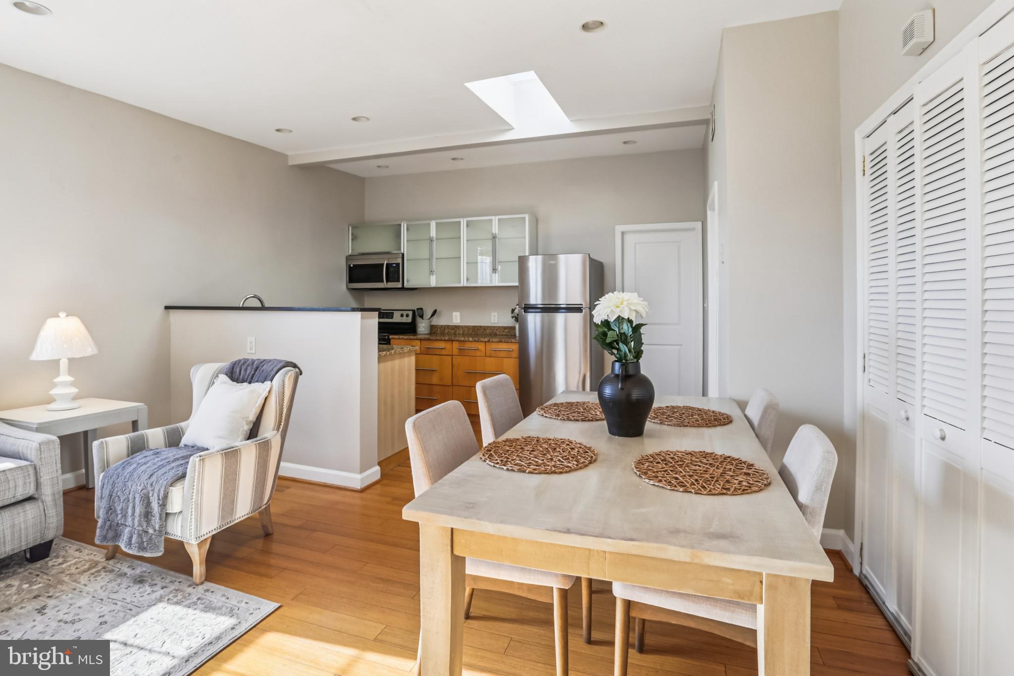 5501 8th Street Northwest, Unit 4 Washington, DC 20011 - Photo 4 of 38 a kitchen with dining table and chairs