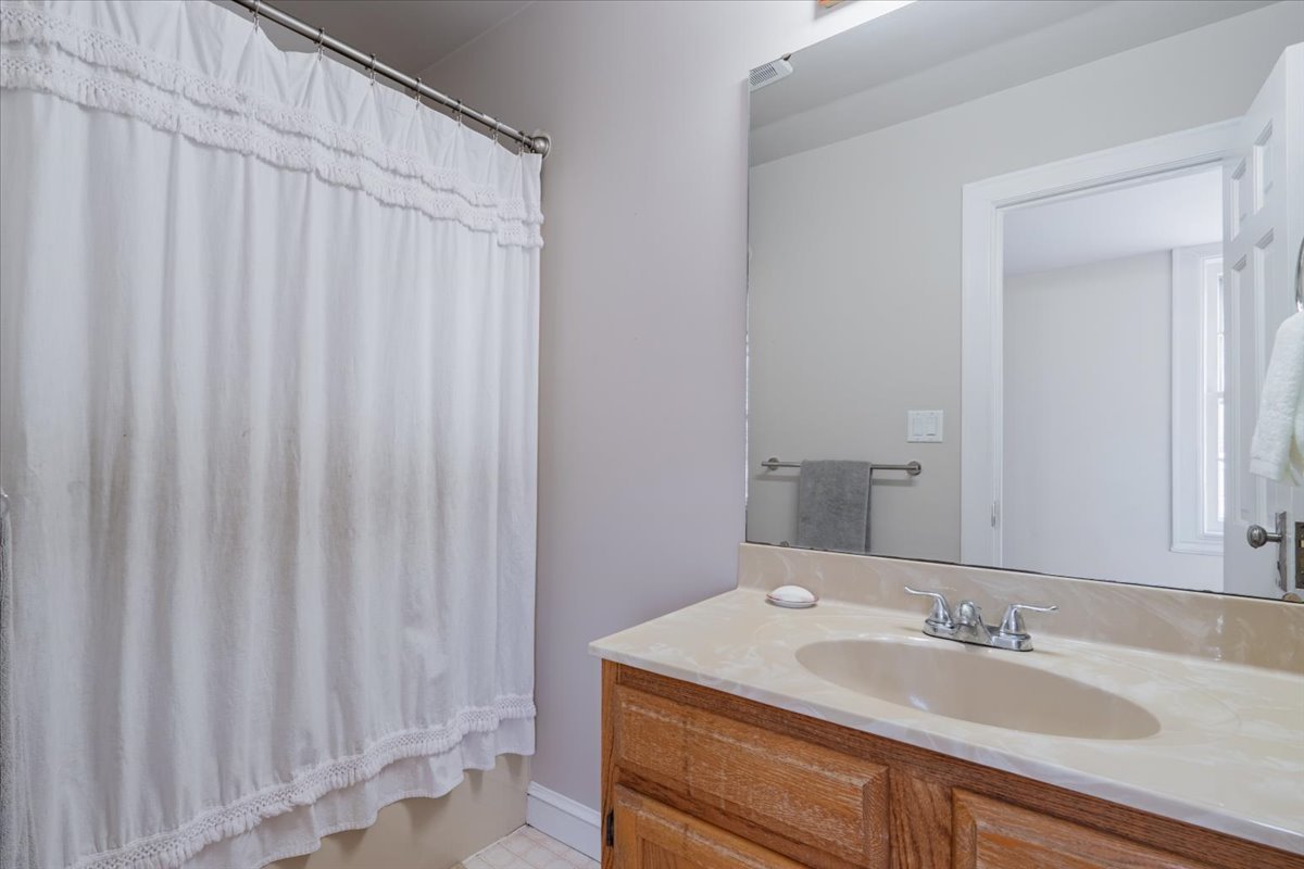 413 Grant Street Normal, IL 61761 - Photo 21 of 40 a bathroom with a sink and a mirror