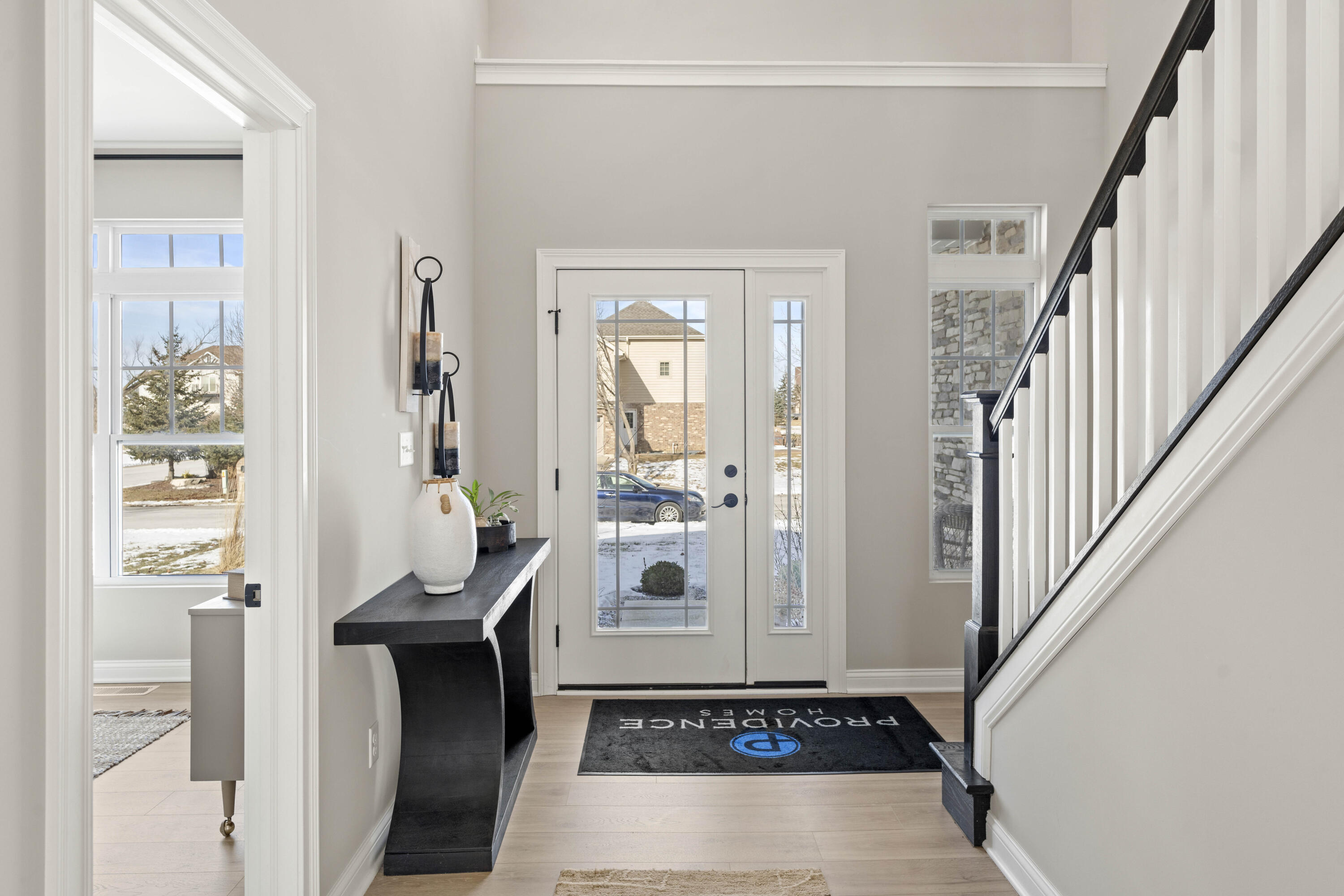 91 Bergamo Lane Crown Point, IN 46307 - Photo 3 of 29 a view of an entryway with wooden floor and a livingroom