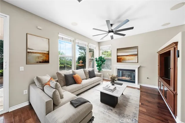 a view of empty room with wooden floor and fireplace