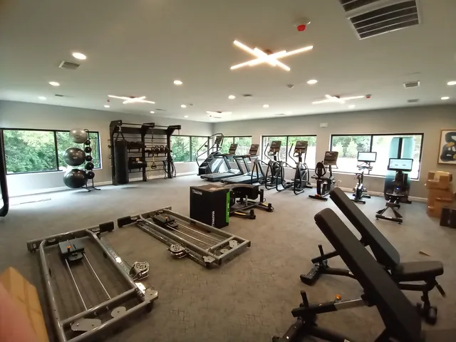 a room with gym equipment and a large window