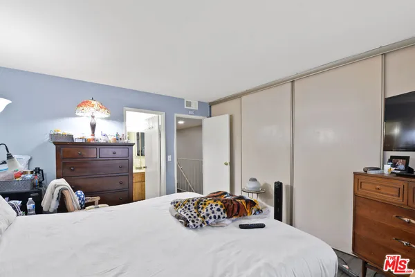 a bedroom with a bed and a dresser