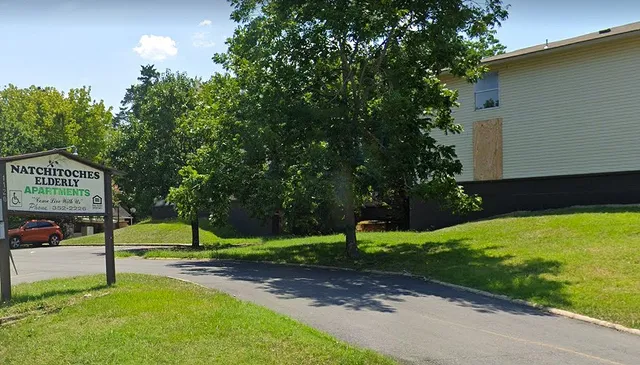 a view of a park with large trees
