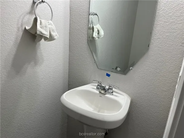 a bathroom with a sink a mirror and vanity