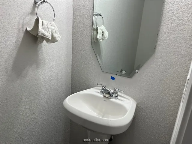 a bathroom with a sink a mirror and vanity