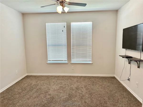 a view of a livingroom with a ceiling fan and a window