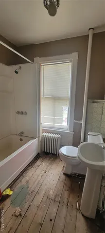 a bathroom with a sink a toilet and bathtub