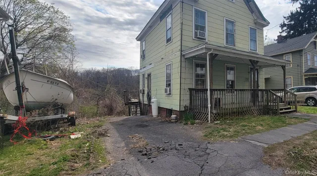 a backyard of a house with barbeque oven